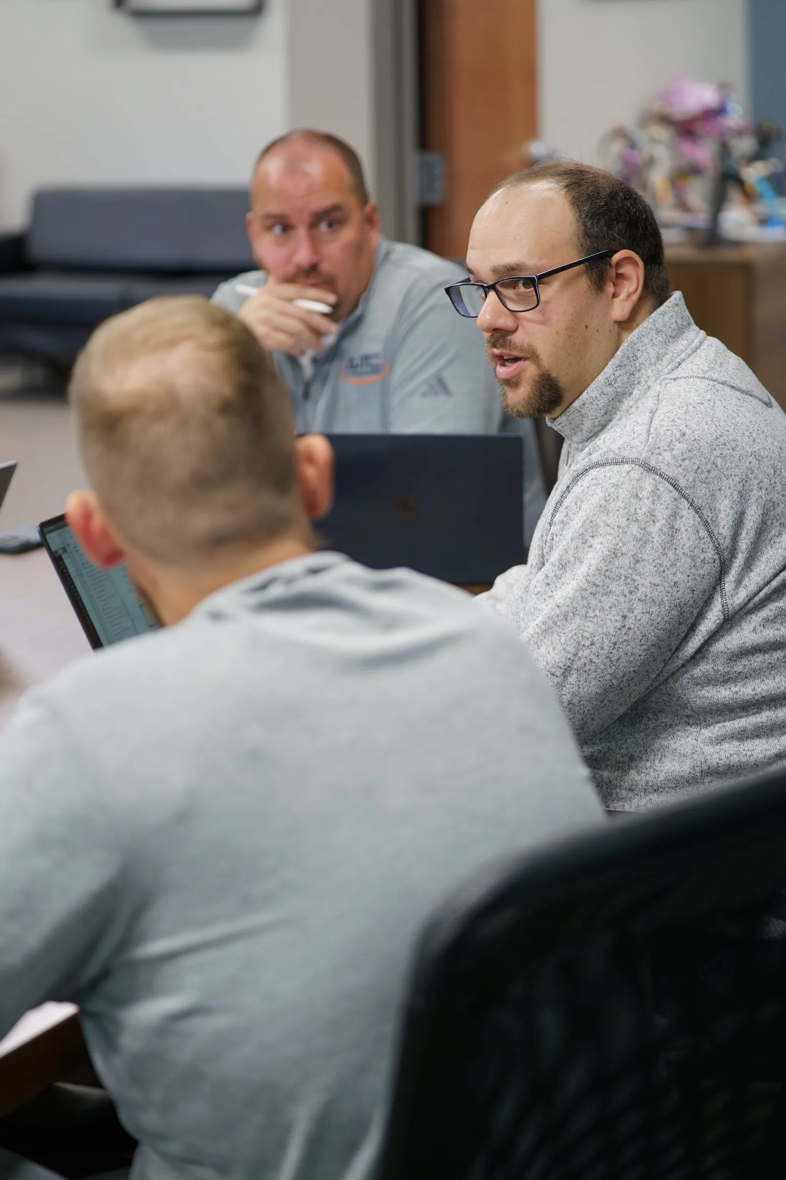 Anthony Giacobbe, founder and CEO of AJTC, leading a team meeting