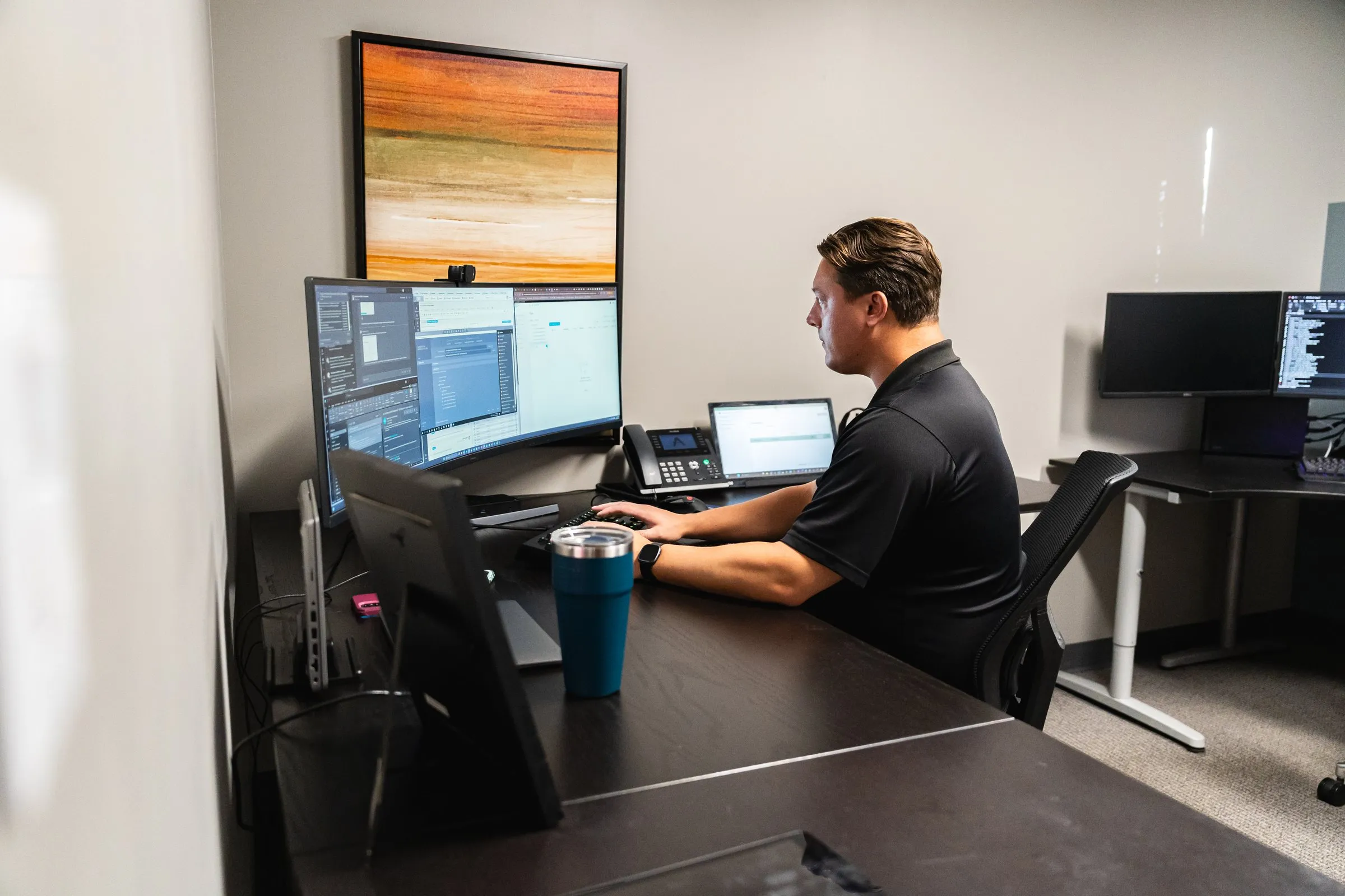 AJTC engineer monitoring client security across multiple screens