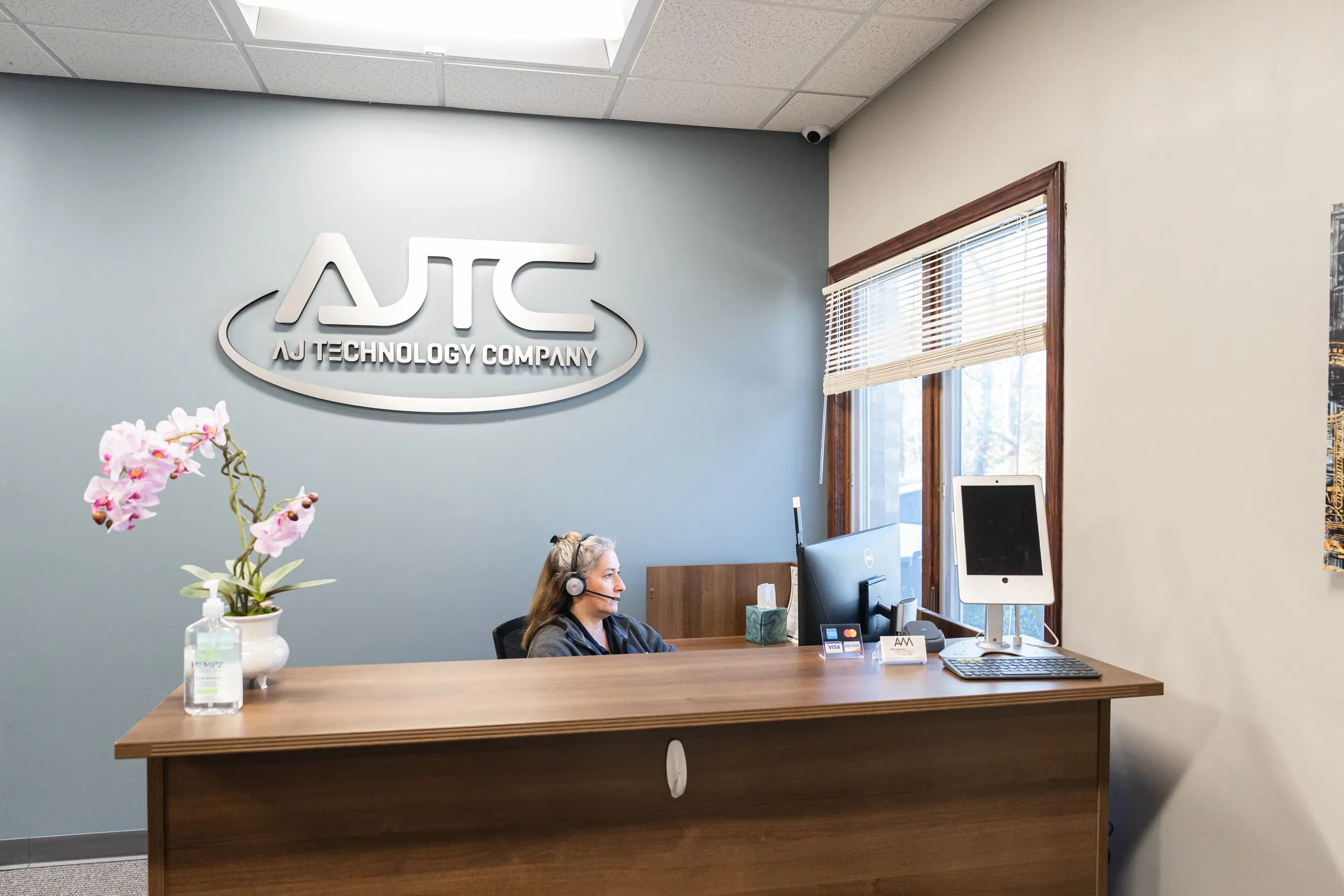AJTC front desk team member answering a call on a headset