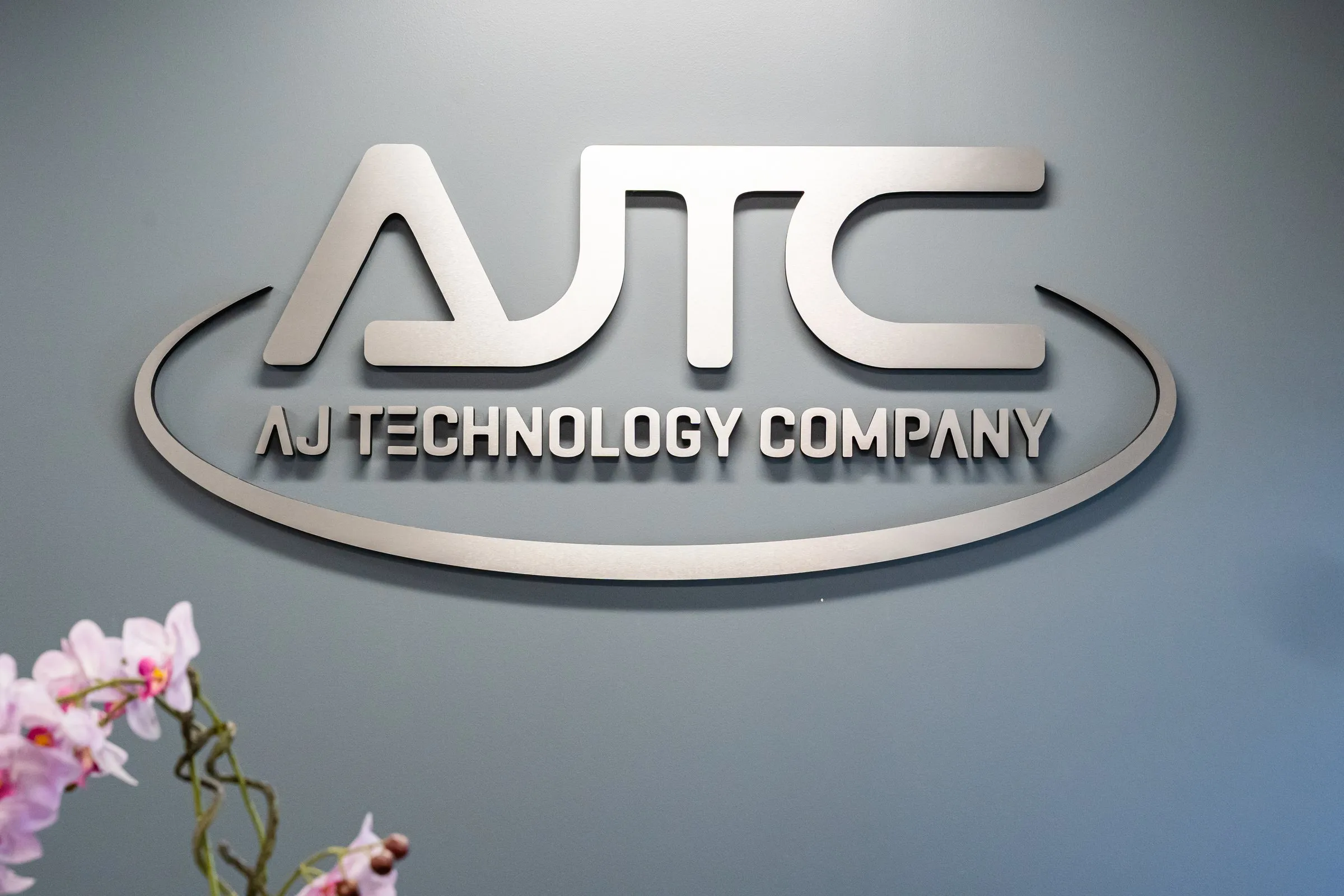AJTC logo wall in the Homer Glen headquarters reception