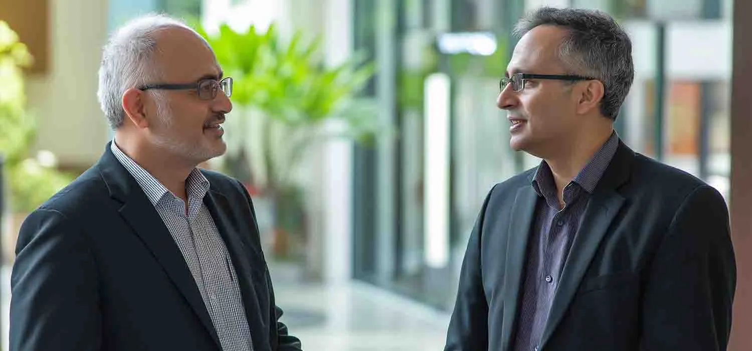 A businessman asking an IT expert, “Why use a managed service provider for business IT solutions