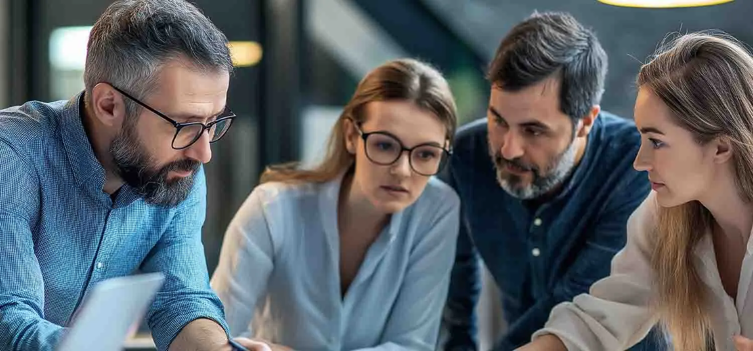 Business owner reviewing a network map with IT consultants during a strategy session