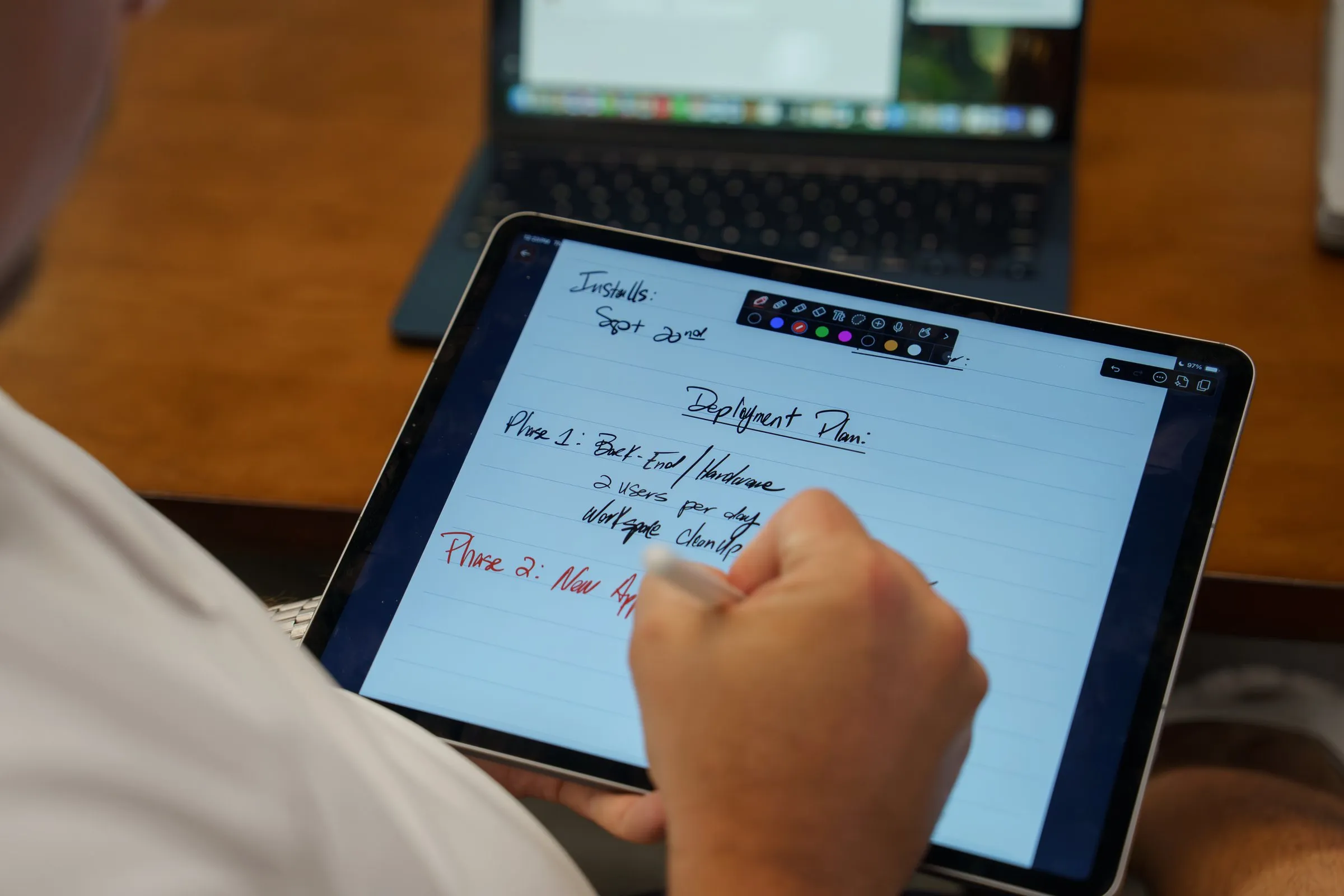 AJTC team member sketching a phased deployment plan on a tablet