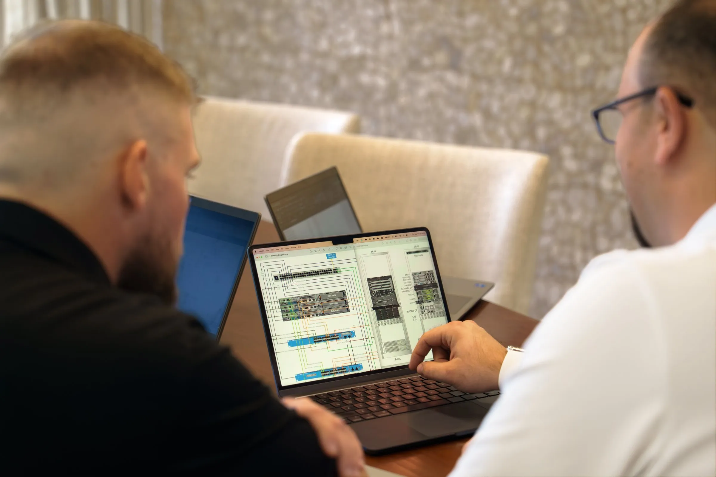 AJTC engineers reviewing a client network diagram together