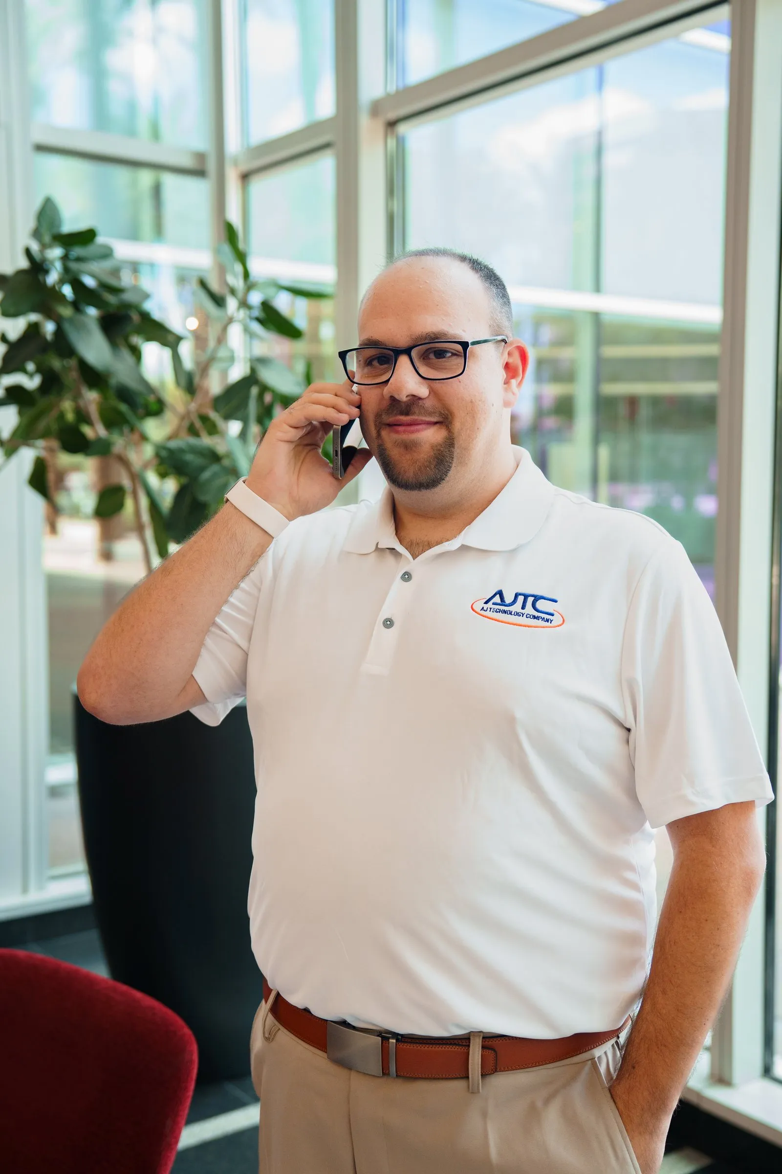 AJTC Phoenix team member taking a call by the window