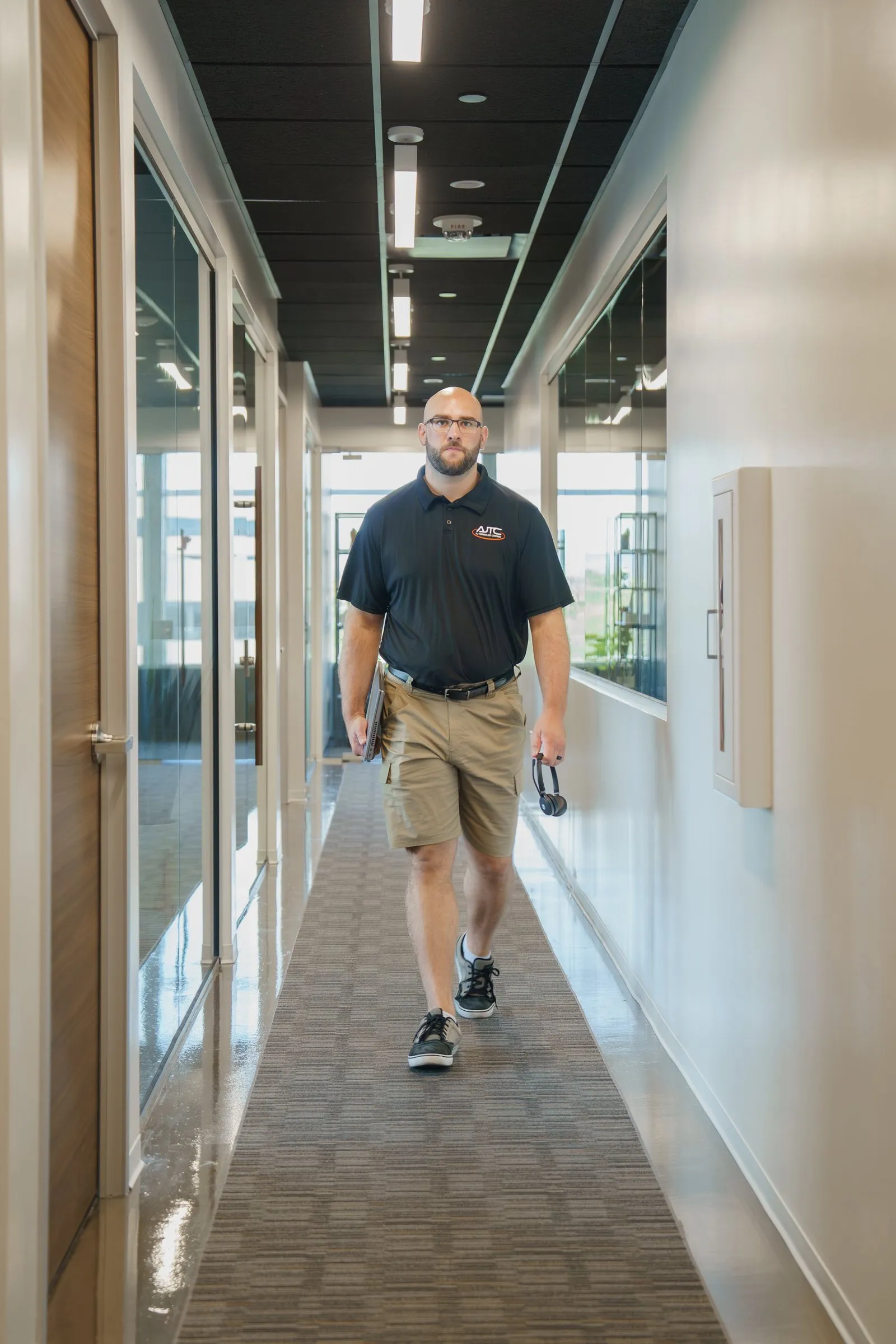 Riley from AJTC Phoenix walking down the office hallway