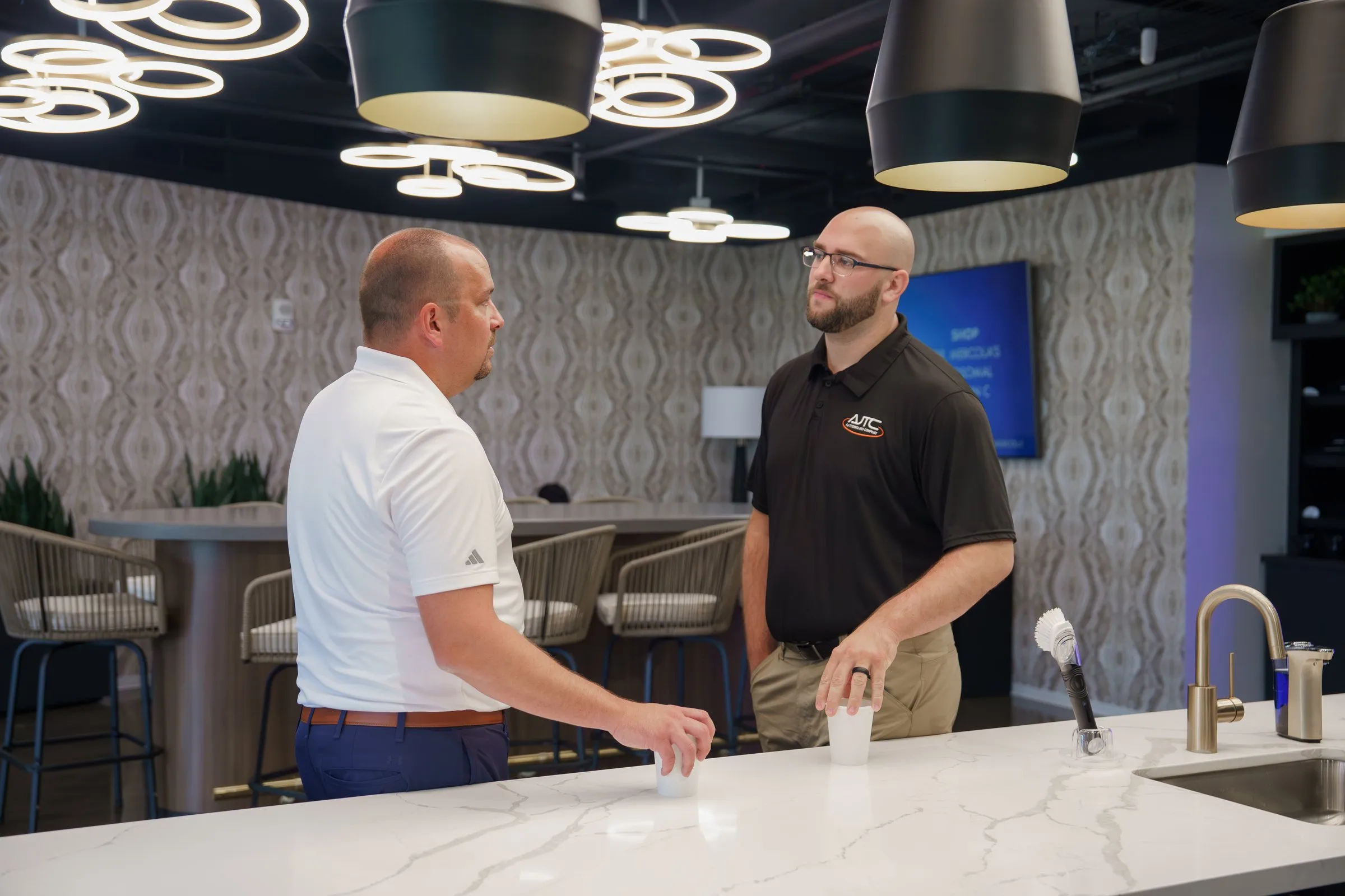 AJTC team member discussing technology strategy with a client in the Phoenix office