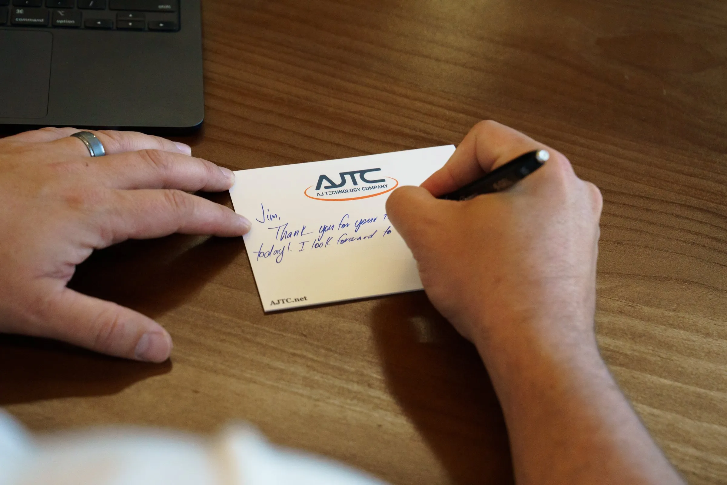 Handwritten thank-you note to a client on an AJTC card